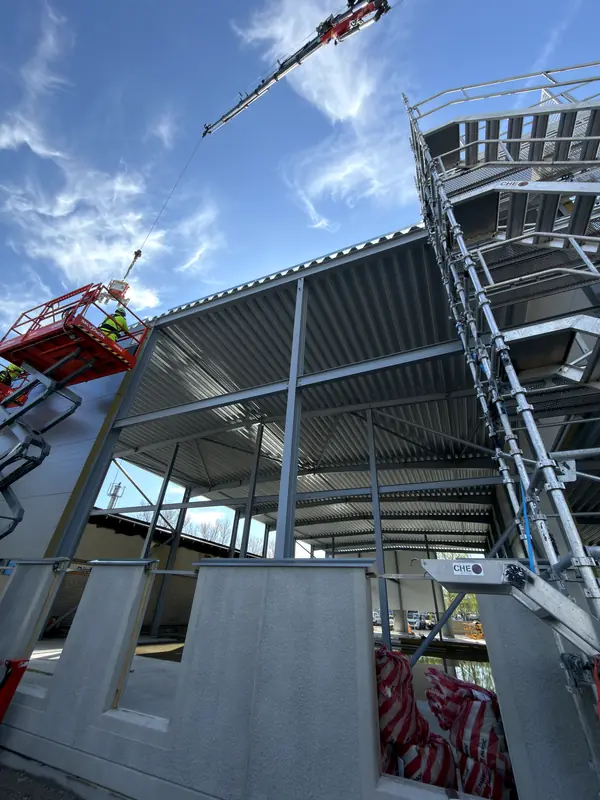 Installation work continuing across the industrial building roof