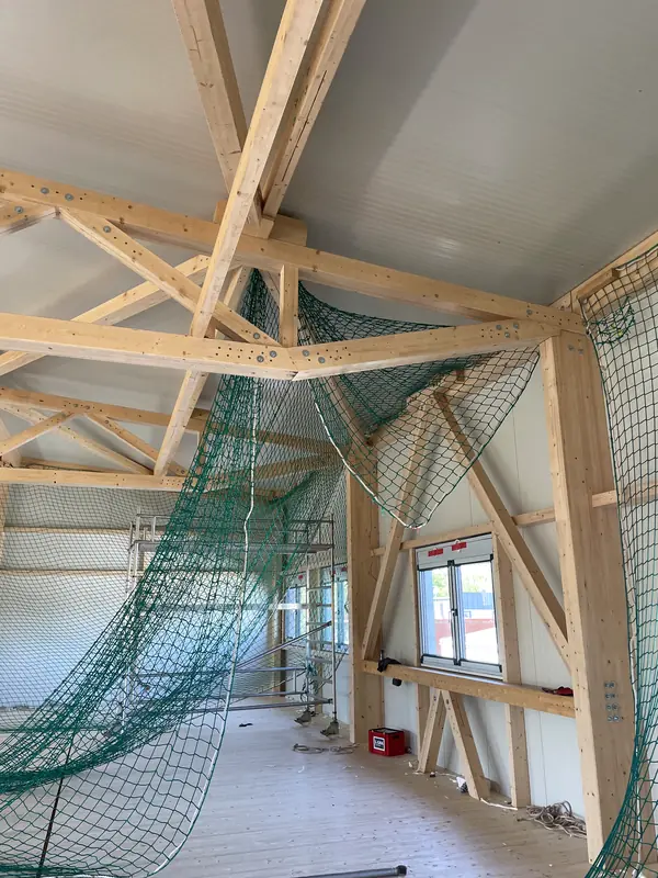 Interior roof installation work above the commercial floor area