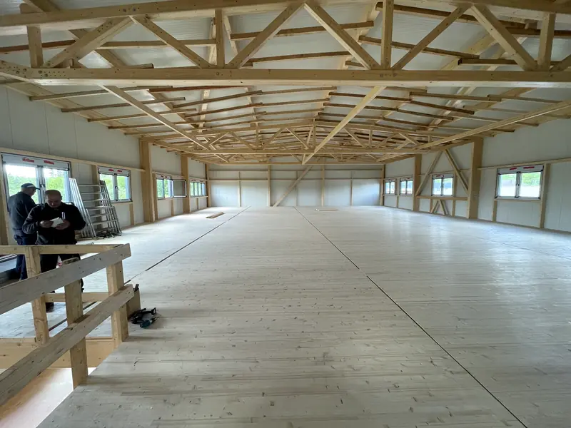 Completed commercial building interior with exposed timber roof trusses