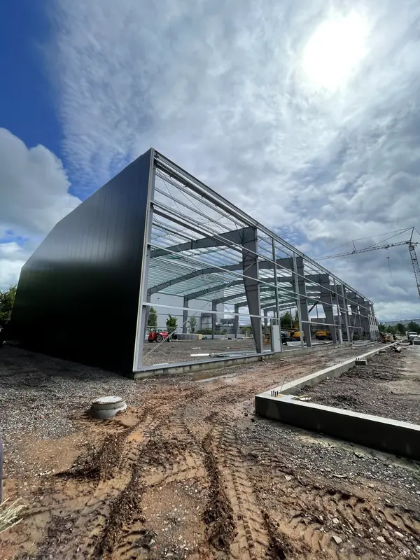 Long run of steel columns and roof beams during warehouse assembly