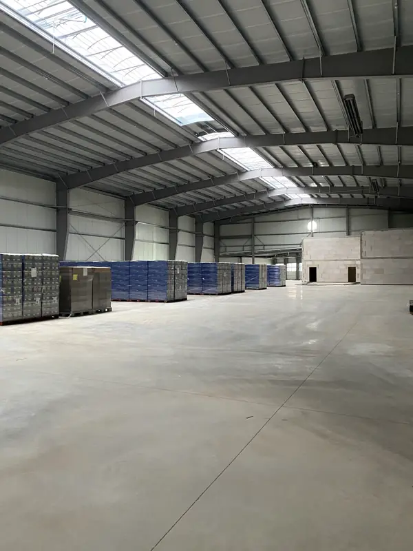 Wide clear-span warehouse interior after structural installation