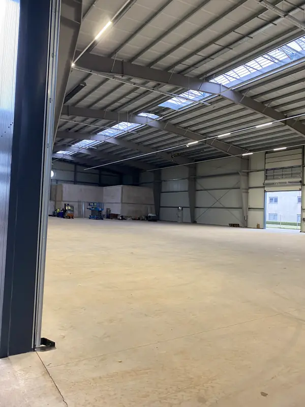 Open warehouse hall showing the completed structural frame